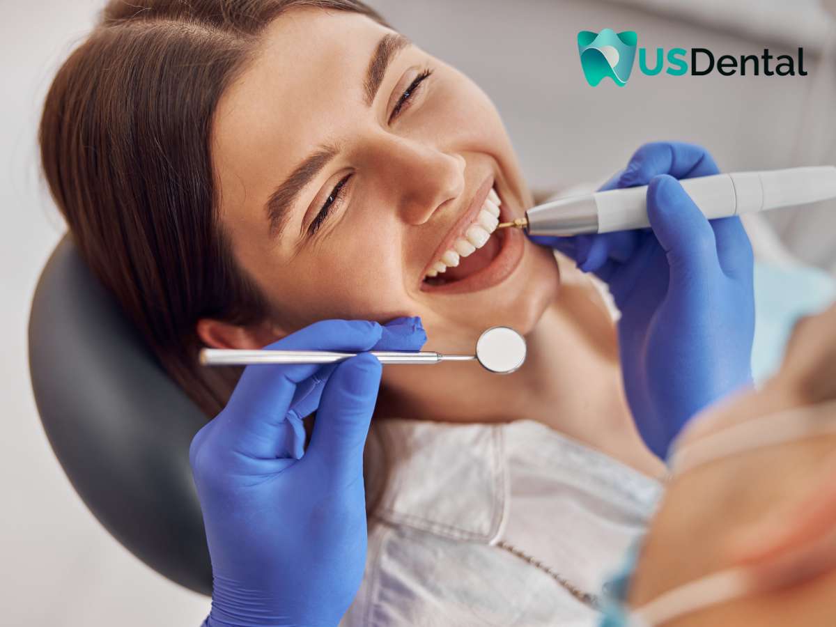 Woman smiling during a dental examination, highlighting the importance of dentures check-ups